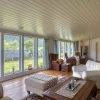 The main living room with a full wall of windows facing the lake offers a fantastic view, and 3 lounges in the living room, a large TV and a sound system integrated in the ceiling that provides indescribably good (and loud) sound. A great wood-burning stove provides lovely heat, and a large door directly out to the terrace.
