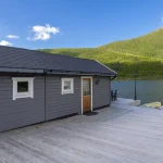 Annex with a breakfast area at the front facing the water, a fireplace and a jetty from which you can fish for trout.